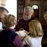 Eine Familie mit 2 Kindern unterhält sich in einer Kirche mit einem Pastor. Alle schaue freundlich und lesen dabei in einer Bibel. Die Eltern führen die Kinder in die gepflogenheiten ein und stärken damit signifikant das Selbstbewusstsein. Eine Familie mit 2 Kindern unterhält sich in einer Kirche mit einem Pastor. Alle schaue freundlich und lesen dabei in einer Bibel. Die Eltern führen die Kinder in die gepflogenheiten ein und stärken damit signifikant das Selbstbewusstsein.